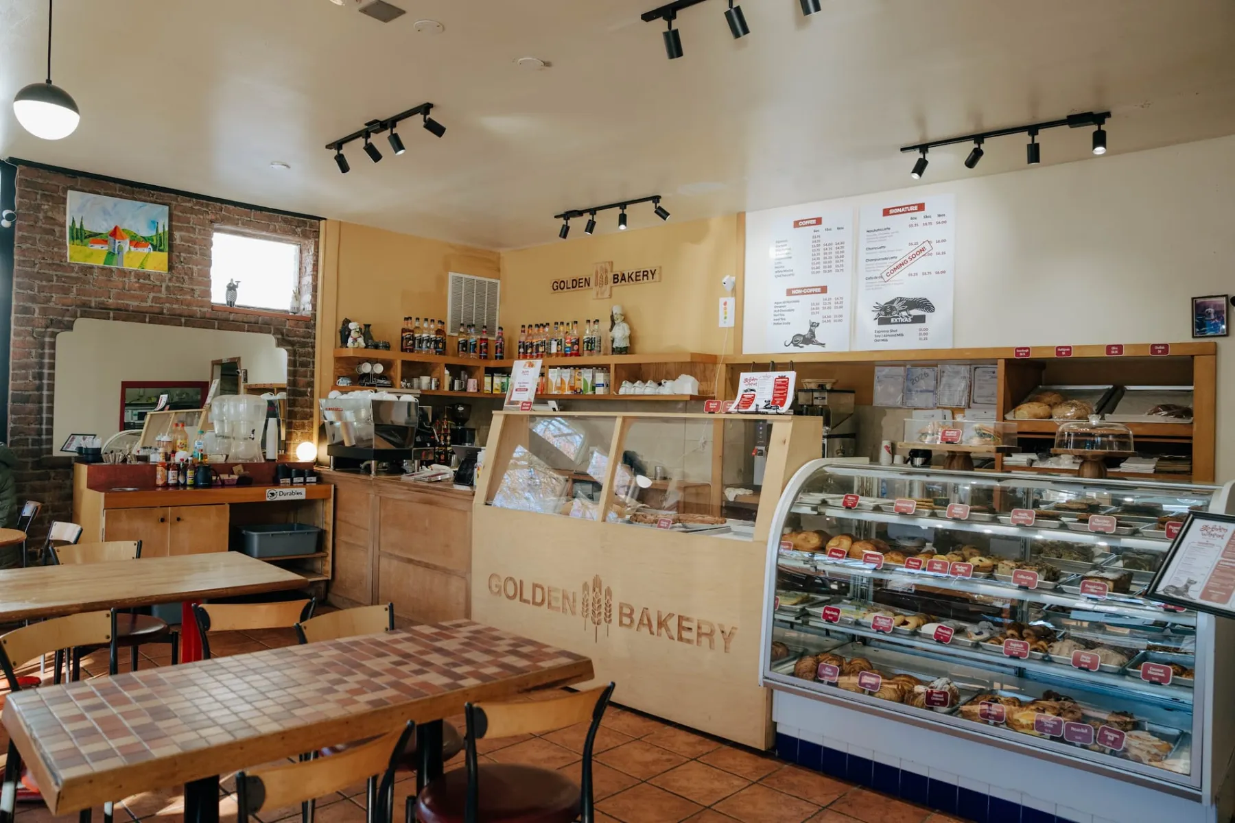 Inside Golden Wheat Bakery: the pastry case, the espresso counter and the wooden counter engraved with three wheat stalks